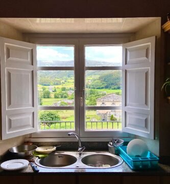 a kitchen with a double sink and open window